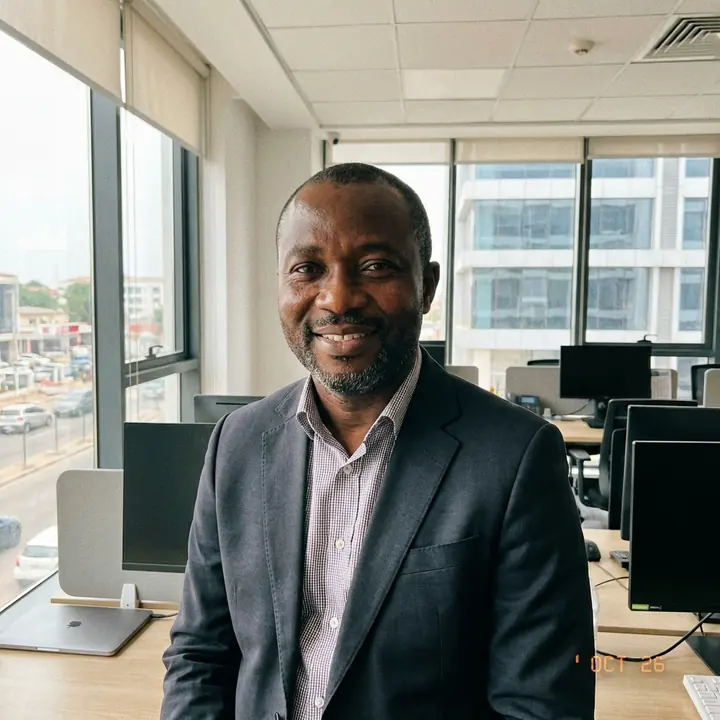 Ghanaian professional in a bright office environment